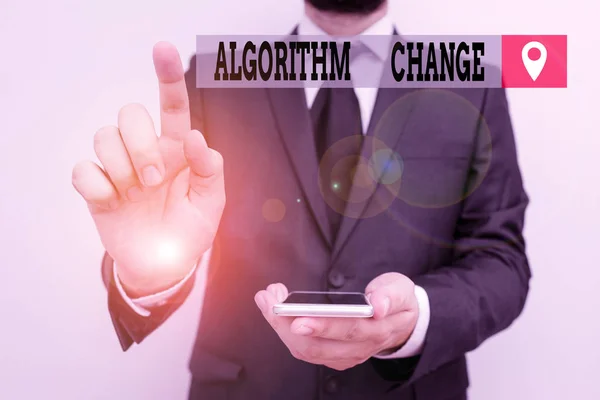 Writing note showing Algorithm Change. Business photo showcasing change in procedure designed to perform an operation Male human wear formal work suit hold smartphone using hand. — Stok fotoğraf