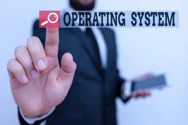 Writing note showing Operating System. Business photo showcasing software that supports a computer s is basic functions Male human wear formal work suit hold hi tech smartphone use hand. — 스톡 사진