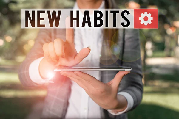 Text sign showing New Habits. Conceptual photo change the routine of behavior that is repeated regularly Outdoor scene with business woman holds lap top with touch screen. — Stock Photo, Image