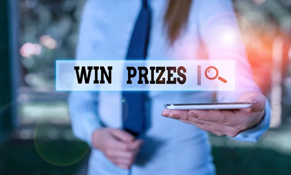 Writing note showing Win Prizes. Business photo showcasing something given for victory in a contest or competition Business woman in shirt holding laptop and mobile phone.