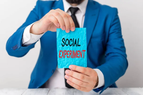 Conceptual hand writing showing Social Experiment. Business photo showcasing the research project conducted with huanalysis subjects Man holds empty paper with copy space in front of him Space. — Stock Photo, Image