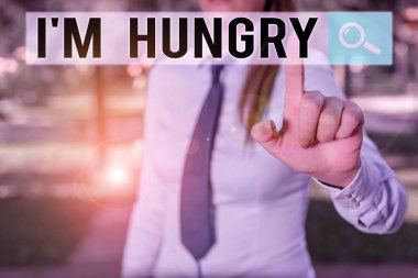 Writing note showing I M Hungry. Business photo showcasing having a strong wish or desire for something to put on stomach Handsome business girl pointing with finger into empty space.