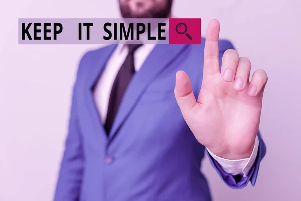 Text sign showing Keep It Simple. Conceptual photo Remain in the simple place or position not complicated Businessman with pointing finger in front of him.
