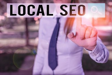 Writing note showing Local Seo. Business photo showcasing optimize your website to rank better for a local audience Handsome business girl pointing with finger into empty space.