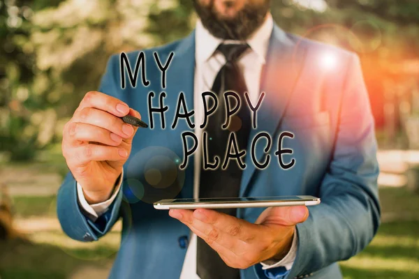 Writing note showing My Happy Place. Business photo showcasing Space where you feel comfortable happy relaxed inspired Businessman in blue suite stands with mobile phone in hands.