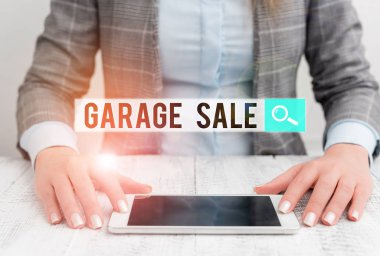 Handwriting text Garage Sale. Concept meaning sale of miscellaneous household goods often held in the garage Business woman sitting with mobile phone on the table.
