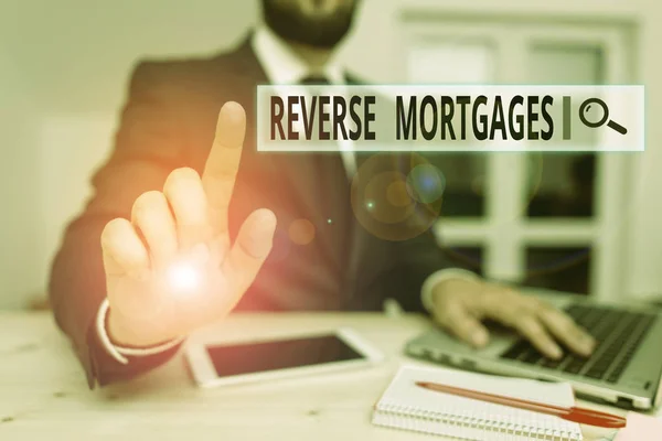 Word writing text Reverse Mortgages. Business concept for borrower to access the unencumbered value of the property Male human wear formal clothes present presentation use hi tech smartphone. — Stock Photo, Image