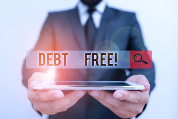 Text sign showing Debt Free. Conceptual photo does not owning any money to any individual or companies Male human wear formal work suit hold smart hi tech smartphone use hands.