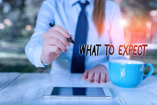 Word writing text What To Expect. Business concept for Confusion about the belief of what will happen in future Business woman sitting by the table with cup of coffee and mobile phone. — Stock Photo, Image