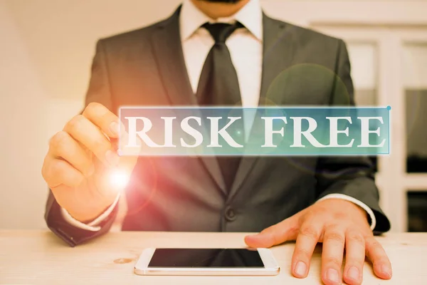 Conceptual hand writing showing Risk Free. Business photo text used to describe something that does not involve any danger Male human wear formal clothes present use hitech smartphone. — Stock Photo, Image