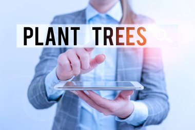 Kelime yazma metni Bitki Ağaçları. Arazi ekimi ve ormancılık için ağaç dikme süreci için iş kavramı cep telefonu ve iş kadınlarıyla iş konsepti.