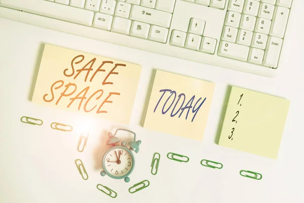 Handwriting text Safe Space. Concept meaning a place or room in which you are protected from harm or danger Empty orange square papers and clock by the pc keyboard with copy space.