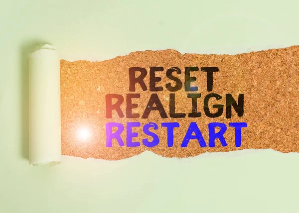 Writing note showing Reset Realign Restart. Business photo showcasing Life audit will help you put things in perspectives Cardboard which is torn placed above a wooden classic table. — Stok fotoğraf