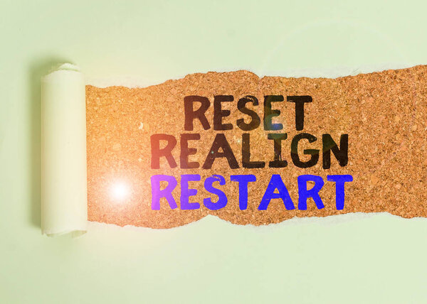 Writing note showing Reset Realign Restart. Business photo showcasing Life audit will help you put things in perspectives Cardboard which is torn placed above a wooden classic table.