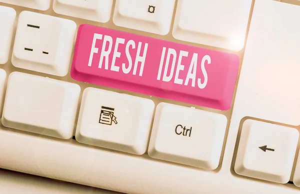 Writing note showing Fresh Ideas. Business photo showcasing the thought or suggestion as to possible course of action White pc keyboard with note paper above the white background. — Stock Photo, Image