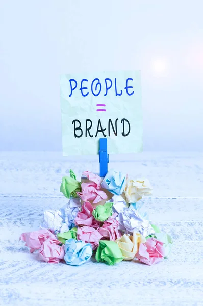 Writing note showing People Brand. Business photo showcasing Personal Branding Defining demonstratingality through the labels Reminder pile colored crumpled paper clothespin wooden space.