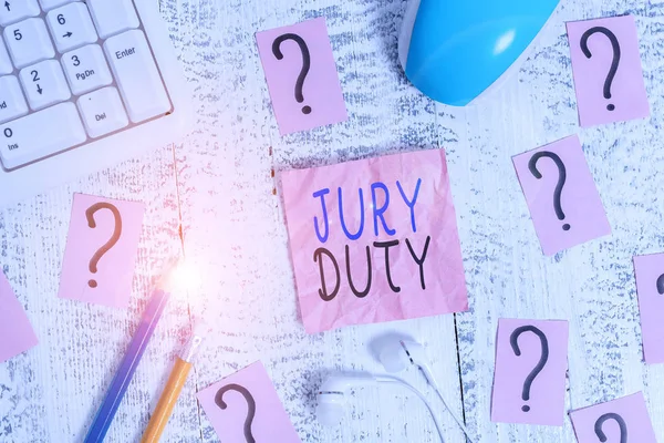 Conceptual hand writing showing Jury Duty. Business photo text obligation or a period of acting as a member of a jury in court Writing tools and scribbled paper on top of the wooden table. — 스톡 사진