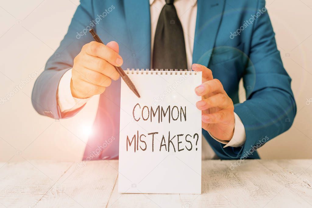 Handwriting text Common Mistakes question. Concept meaning repeat act or judgement misguided or wrong Man holds empty paper with copy space in front of him Copy Space.