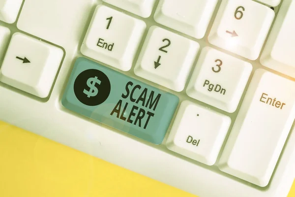 Writing note showing Scam Alert. Business photo showcasing warning someone about scheme or fraud notice any unusual White pc keyboard with note paper above the white background. — Stock Photo, Image