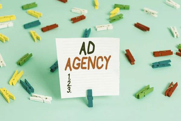 Word writing text Ad Agency. Business concept for business dedicated to creating planning and handling advertising Colored clothespin papers empty reminder blue floor background office pin.