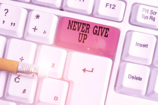 Word writing text Never Give Up. Business concept for Keep trying until you succeed follow your dreams goals White pc keyboard with empty note paper above white background key copy space. — Stockfoto