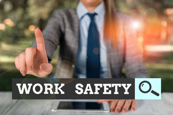 Text sign showing Work Safety. Conceptual photo policies and procedures in place to ensure safety in workplace Female business person sitting by table holding mobile phone.
