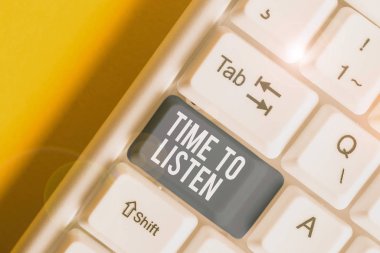 Conceptual hand writing showing Time To Listen. Business photo text Give attention to someone or something in order to hear White pc keyboard with note paper above the white background.