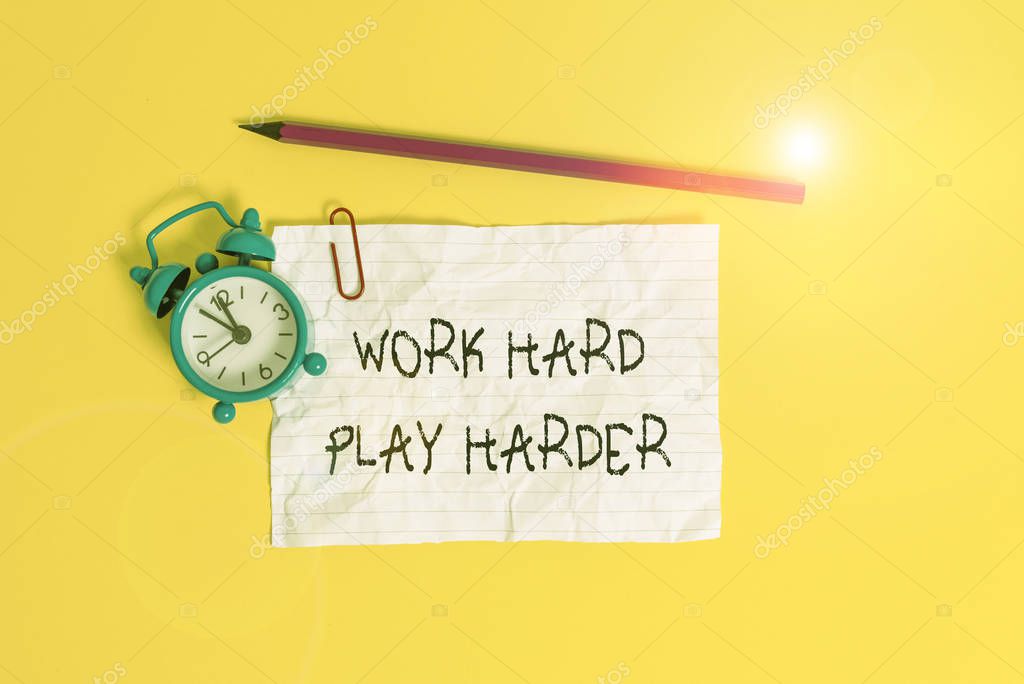 Conceptual hand writing showing Work Hard Play Harder. Business photo showcasing a Balance Life Have a Break Destressing to Relax Metal alarm clock ccrushed sheet pencil colored background.