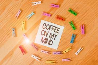 Writing note showing Coffee On My Mind. Business photo showcasing Addiction to Coffee Starbucks Thinking of breaktime Colored clothespin papers empty reminder wooden floor background office.