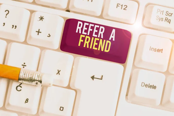Text sign showing Refer A Friend. Conceptual photo Recommendation Appoint someone qualified for the task White pc keyboard with empty note paper above white background key copy space. — Stock Photo, Image