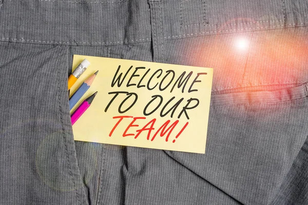 Writing note showing Welcome To Our Team. Business photo showcasing introducing another demonstrating to your team mates Writing equipment and yellow note paper inside pocket of man trousers. — Stock Photo, Image