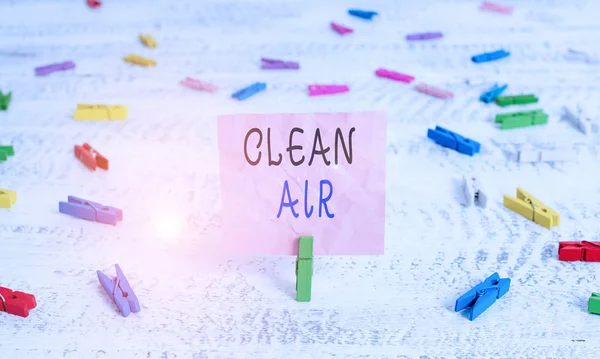 Writing note showing Clean Air. Business photo showcasing air that has no harmful levels of dirt and chemicals in it Green clothespin white wood background reminder office supply.