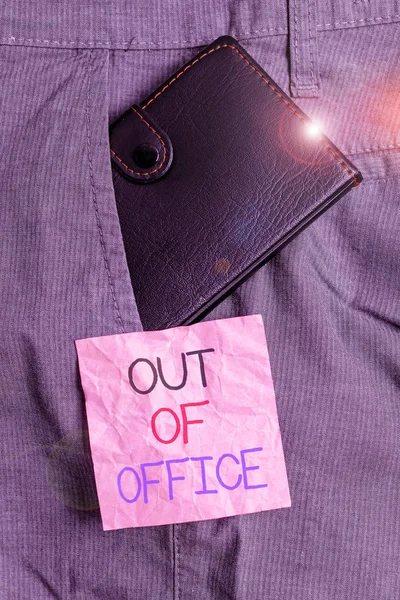 Text sign showing Out Of Office. Conceptual photo Outside the job Nobody in business Break Leisure Relax time Small little wallet inside man trousers front pocket near notation paper.