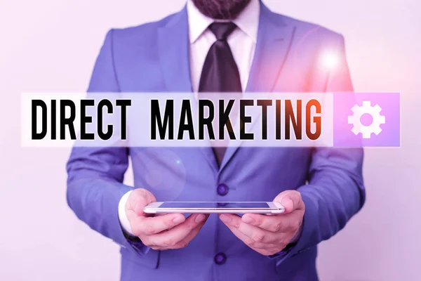 Text sign showing Direct Marketing. Conceptual photo business of selling products directly to the public Businessman in blue suite with a tie holds lap top in hands.