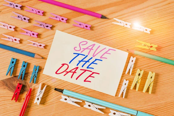 Handwriting text Save The Date. Concept meaning Systematized events Scheduled activity Recorded Filed Colored clothespin papers empty reminder wooden floor background office. — Stock Photo, Image