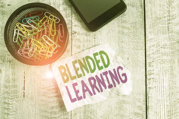 Writing note showing Blended Learning. Business photo showcasing combines traditional classroom lessons with online teaching Wrinkle paper and cardboard placed above wooden background.