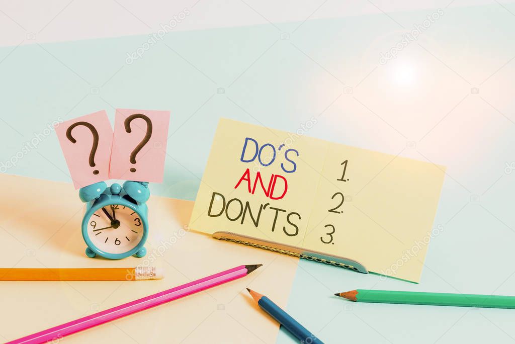 Text sign showing Do S And Don Ts. Conceptual photo Technologically complication of making a decision Mini size alarm clock beside stationary placed tilted on pastel backdrop.