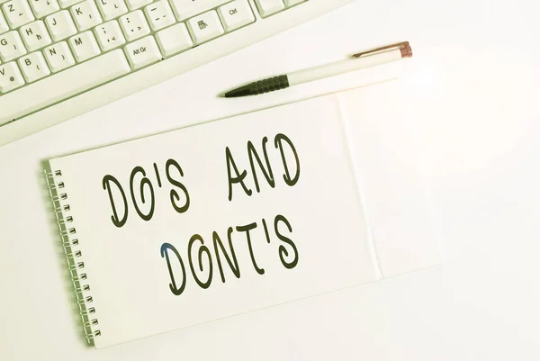 Conceptual hand writing showing Do S Is And Dont S Is. Business photo showcasing advising Rules or customs concerning some activity White pc keyboard with note paper above white background. — Stock Photo, Image