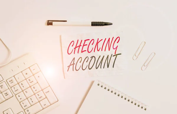 Text sign showing Checking Account. Conceptual photo bank account that allows you easy access to your money White pc keyboard with empty note paper and pencil above white background.