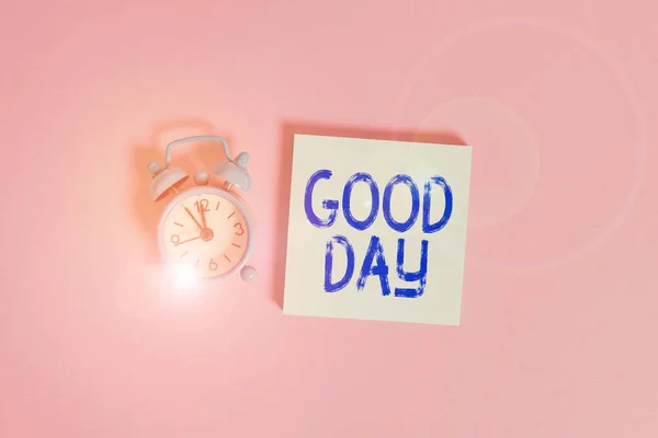 Writing note showing Good Day. Business photo showcasing Enjoying the moment with great weather Having lots of fun Vintage alarm clock wakeup blank notepad sticky note colored background.