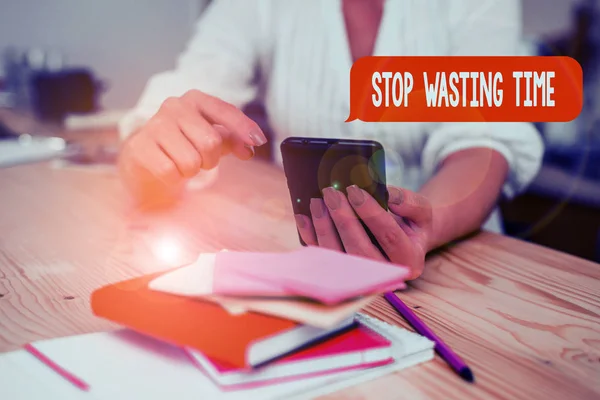 Word writing text Stop Wasting Time. Business concept for advising demonstrating or group start planning and use it woman using smartphone office supplies technological devices inside home. — Stock Photo, Image