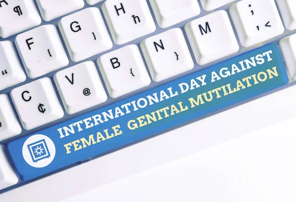 Word writing text International Day Against. Business concept for International Day Against Female Genital Mutilation White pc keyboard with empty note paper above white background key copy space.