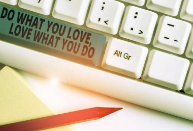 Handwriting text writing Do What You Love Love What You Do. Concept meaning you able doing stuff you enjoy it to work in better places then White pc keyboard with empty note paper above white backgrou