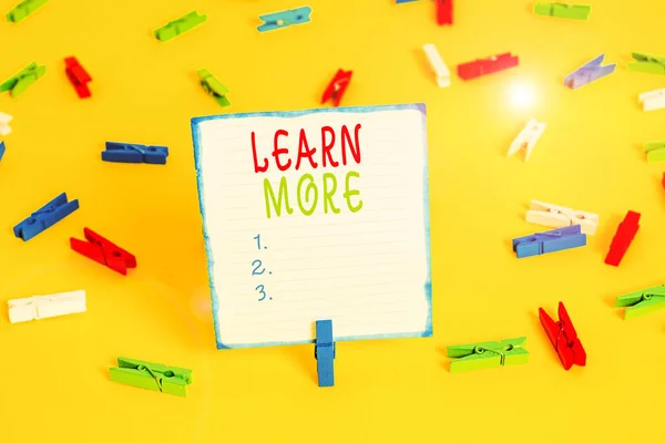 Handwriting text Learn More. Concept meaning knowledge or skill acquired by instruction Considerable learning Colored clothespin papers empty reminder yellow floor background office.