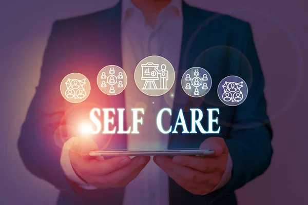 Writing note showing Self Care. Business photo showcasing Give comfort to your own body without professional consultant Male wear formal work suit presenting presentation smart device. — Stock Photo, Image