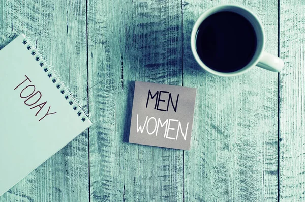 Conceptual hand writing showing Men Women. Business photo text The state where in a boy or a girl turns to be a mature adult Stationary placed next to a coffee cup above wooden table. — Stock Photo, Image