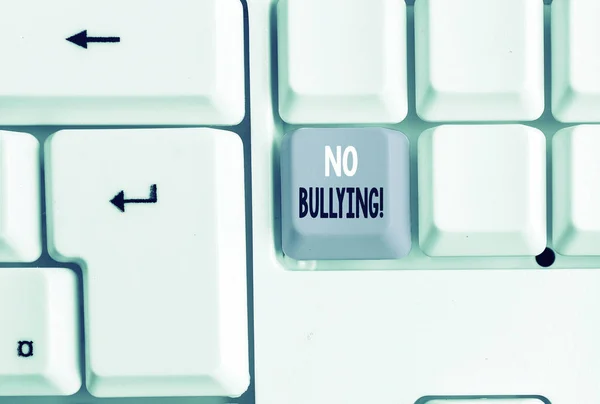 Text sign showing No Bullying. Conceptual photo stop aggressive behavior among children power imbalance White pc keyboard with empty note paper above white background key copy space.