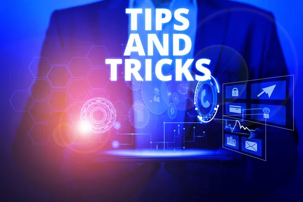 Text sign showing Tips And Tricks. Conceptual photo piece of inside facts specially in betting or investing Male human wear formal work suit presenting presentation using smart device.