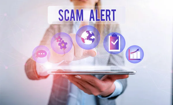 Conceptual hand writing showing Scam Alert. Business photo showcasing warning someone about scheme or fraud notice any unusual Female human wear formal work suit presenting smart device.