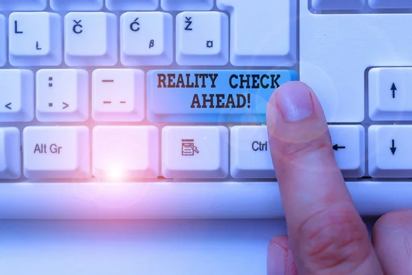 Text sign showing Reality Check Ahead. Conceptual photo makes them recognize truth about situations or difficulties White pc keyboard with empty note paper above white background key copy space.